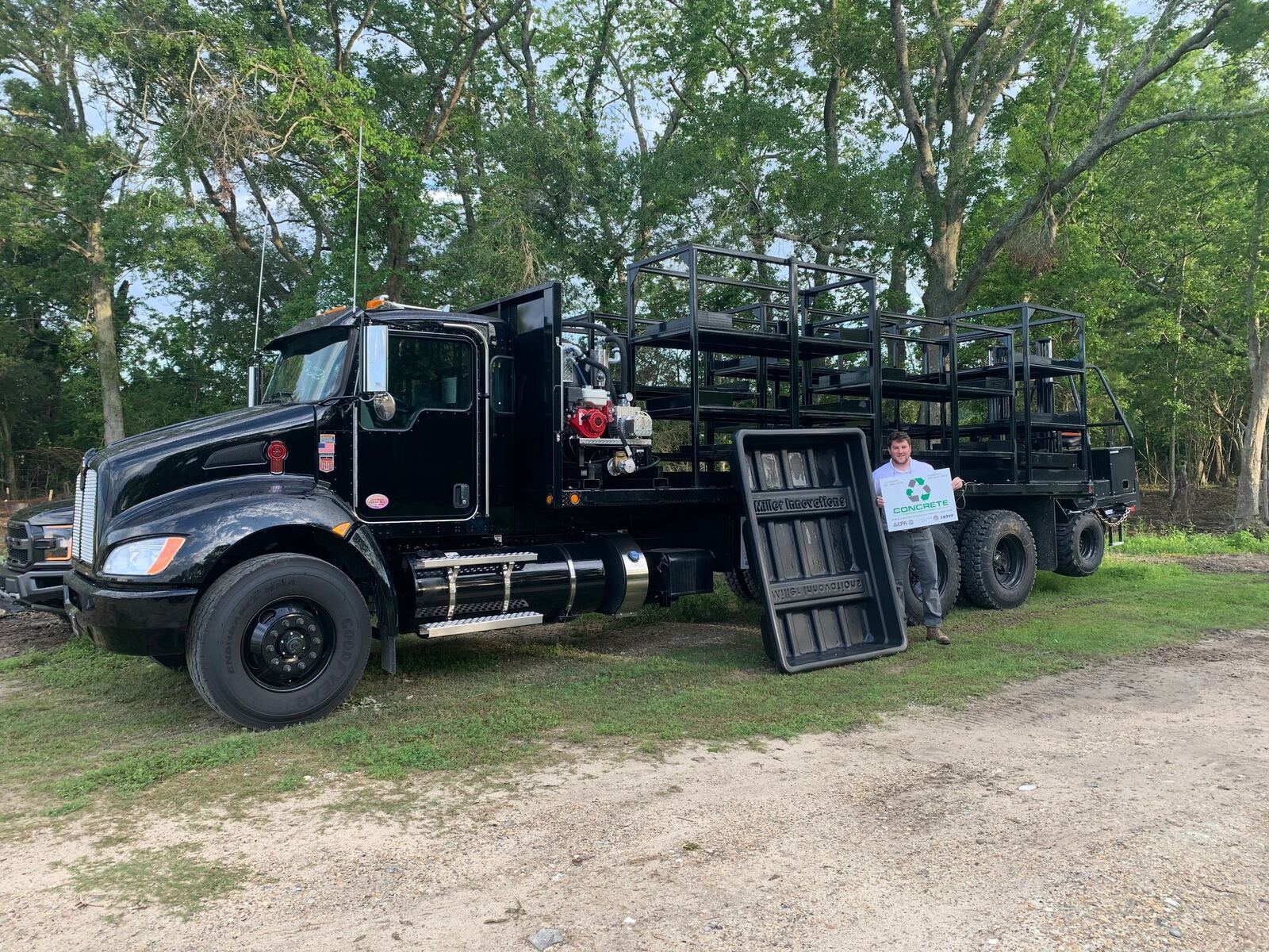 The specialized truck that transports thirteen concrete washout basins at once